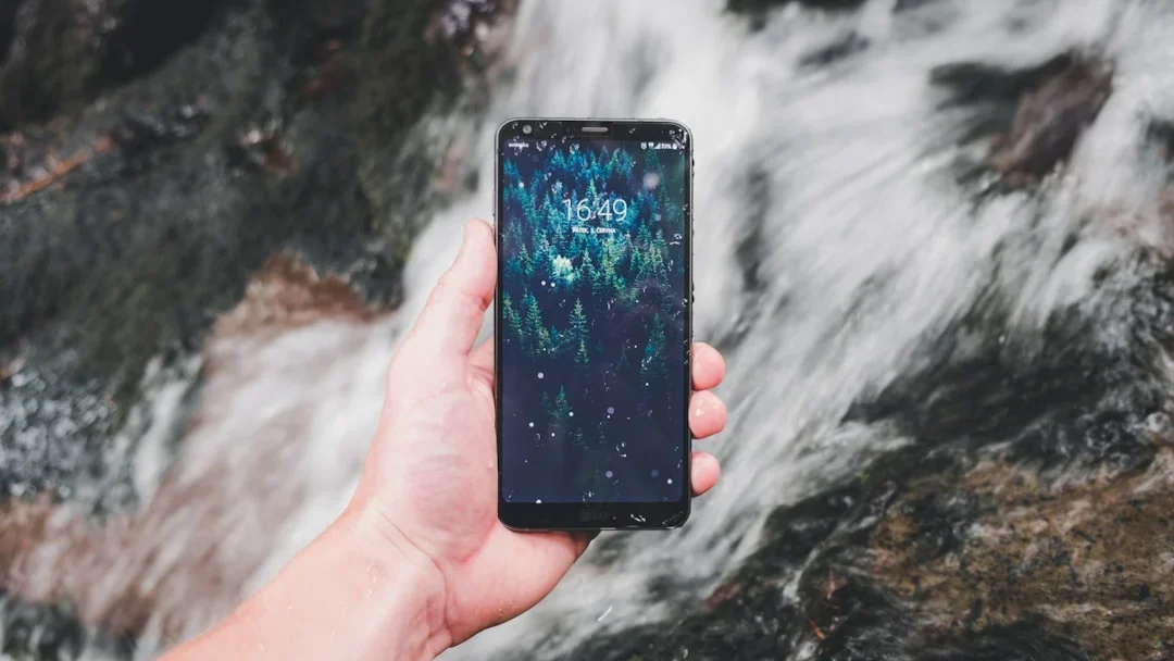 Hand Holding Phone Broken Screen